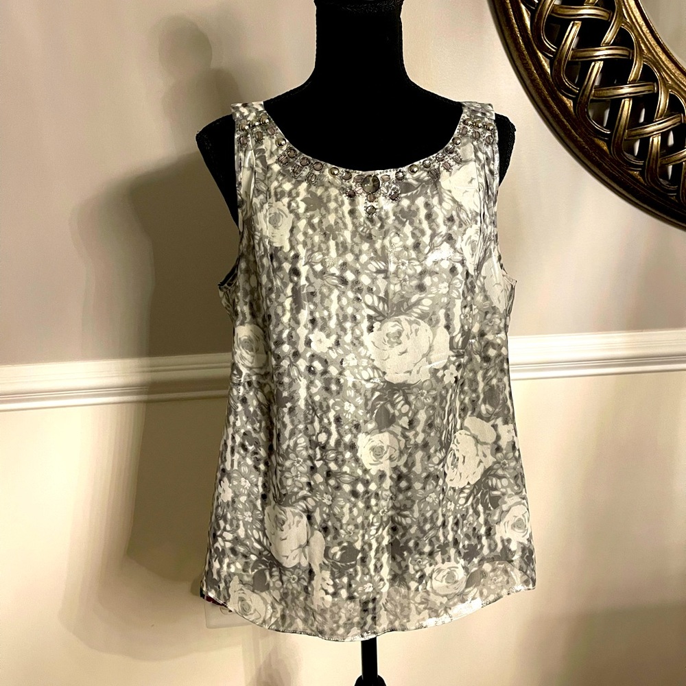 Beautiful white silver sleeveless satiny fabric. Perfect for the holidays.